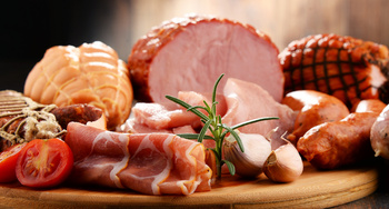 Assorted meat products including ham and sausages.
